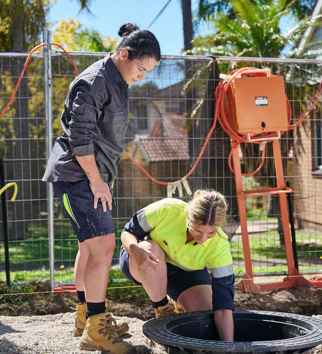 Two civil workers in Bisley workwear at an open pit