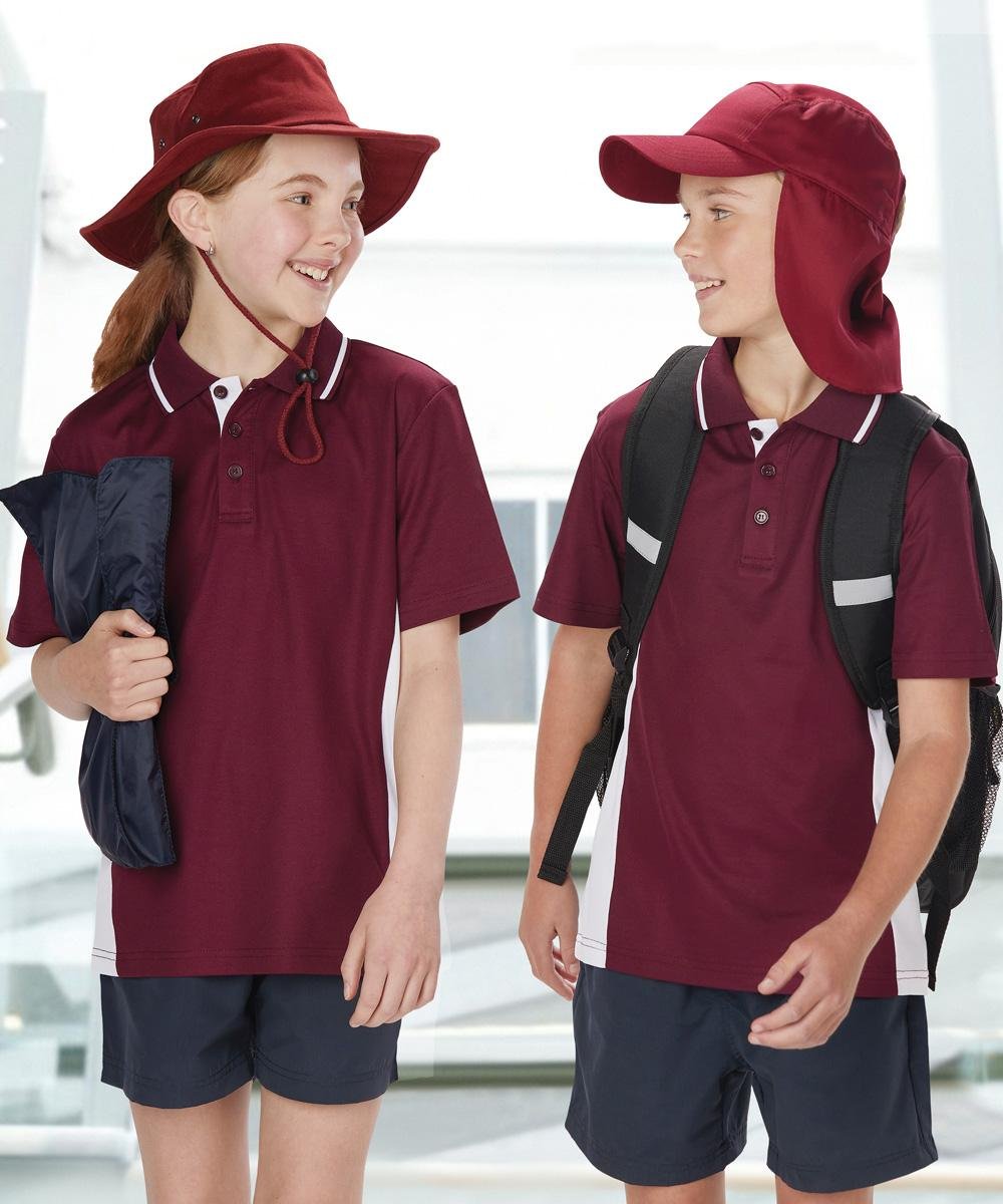 Two kids in Winning Spirit school polos and hats