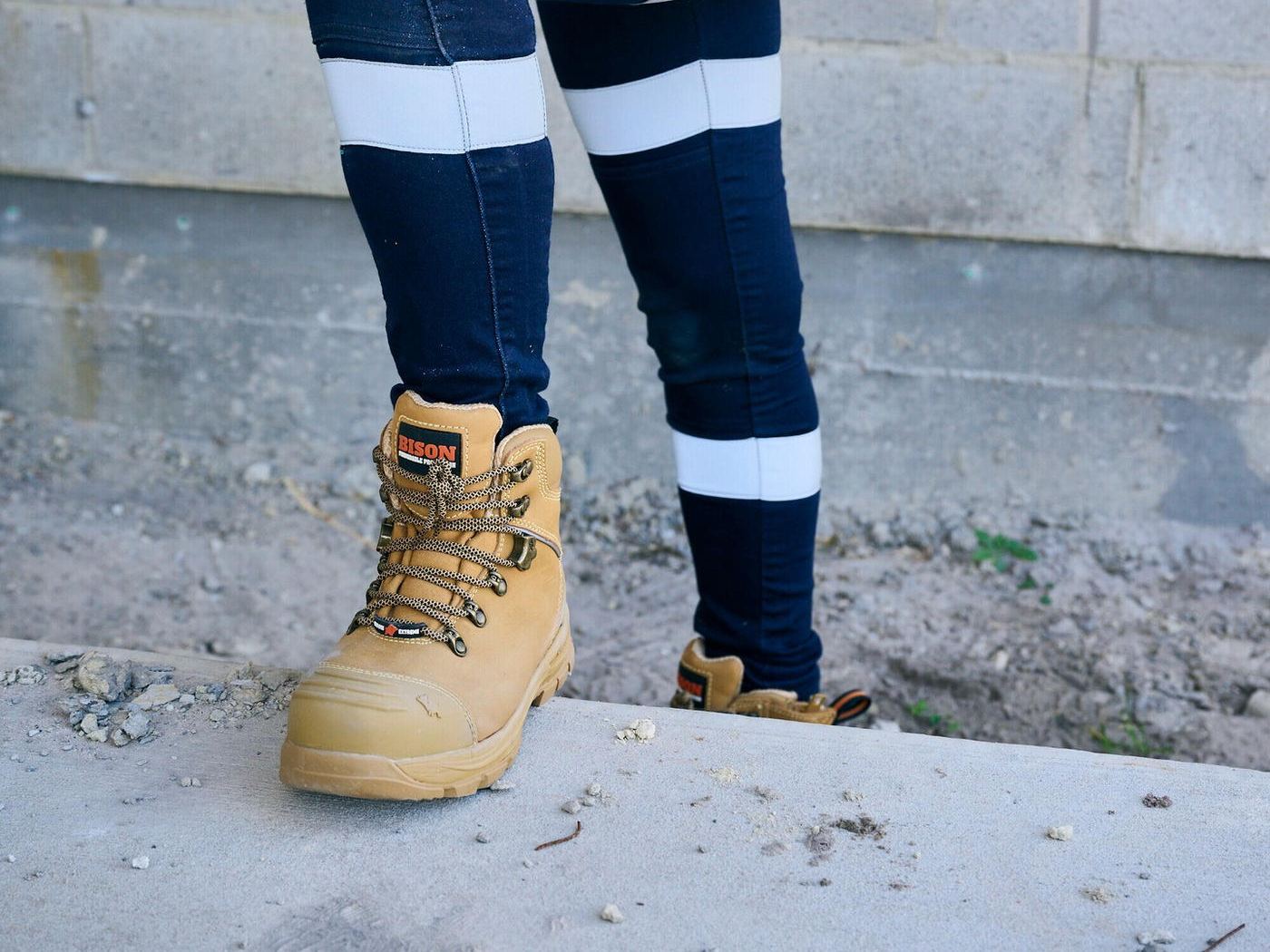 Bisley taped work pants and tan safety boots on site
