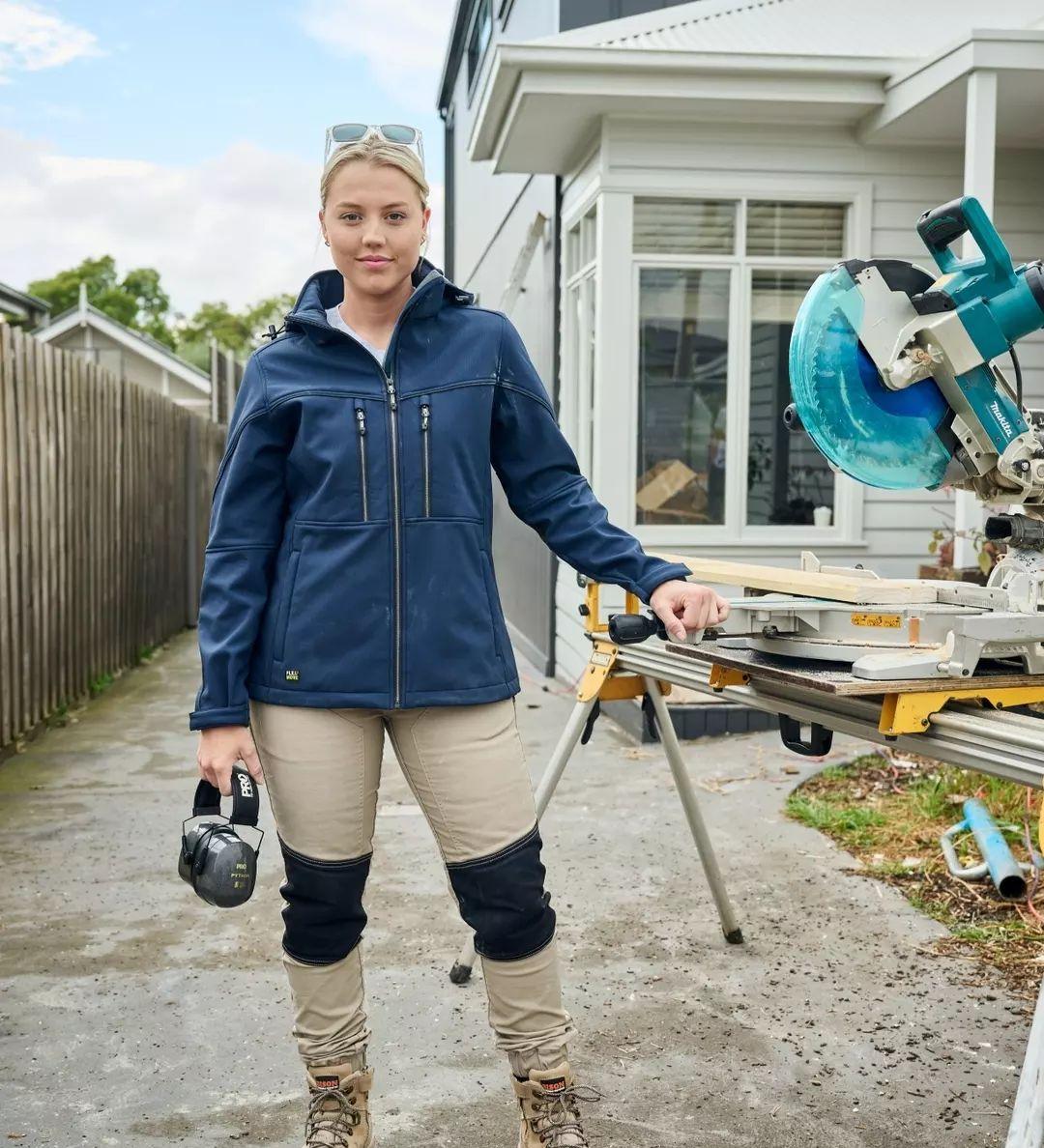 Woman in a navy Bisley soft shell jacket on site